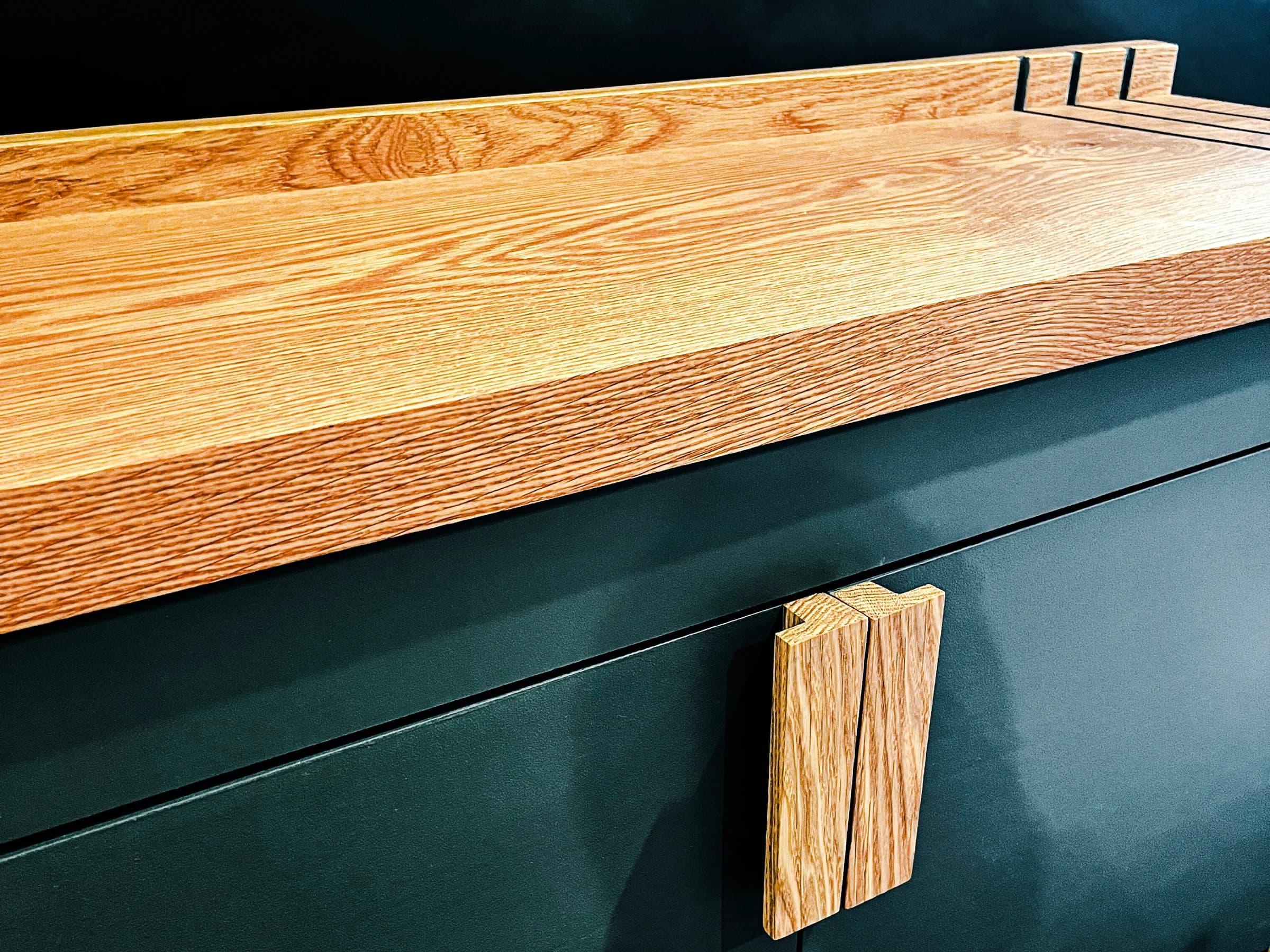 Custom green cabinet with a solid wood top and matching wood pull