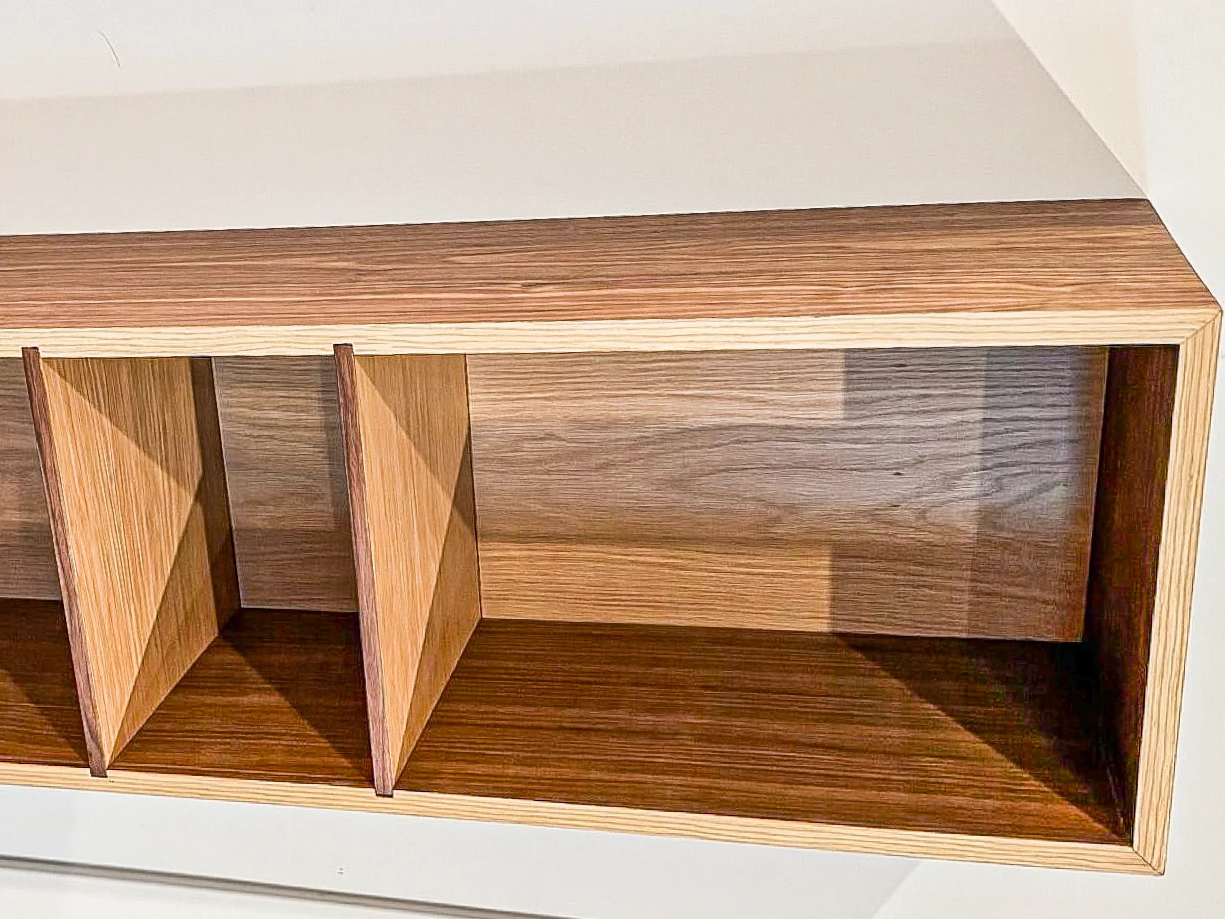 Wall-mounted wood shelving with open compartments