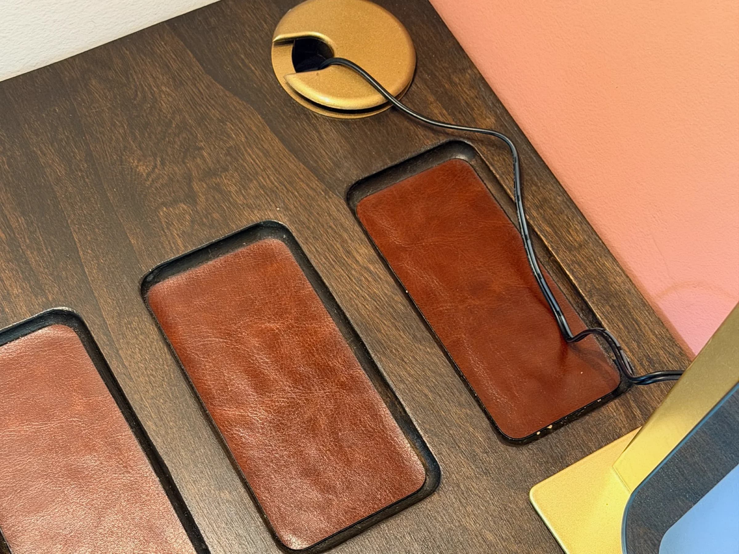 Custom wood desktop with leather-lined compartments and a cable opening