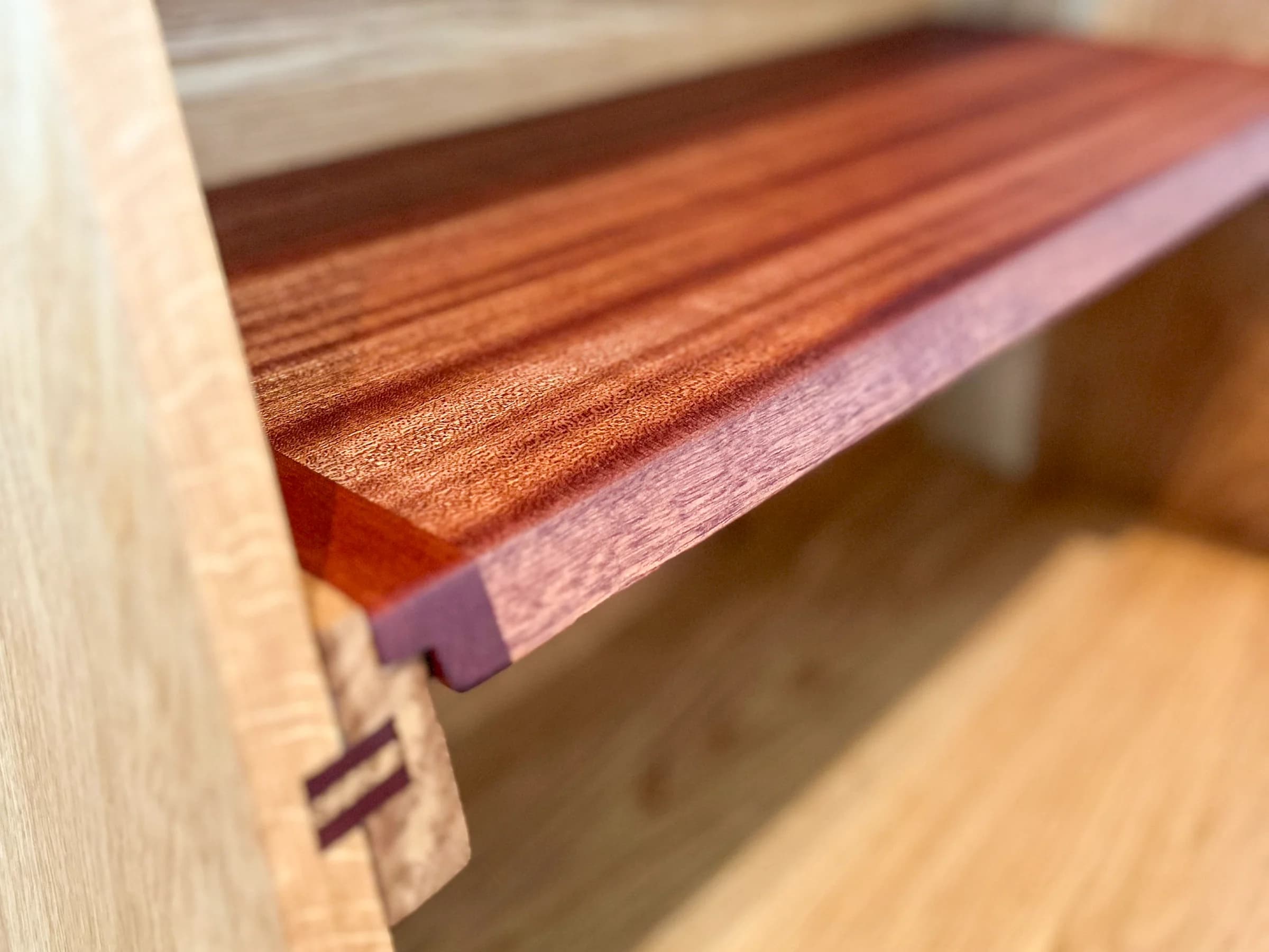 Close-up of a solid wood shelf and fitted joinery