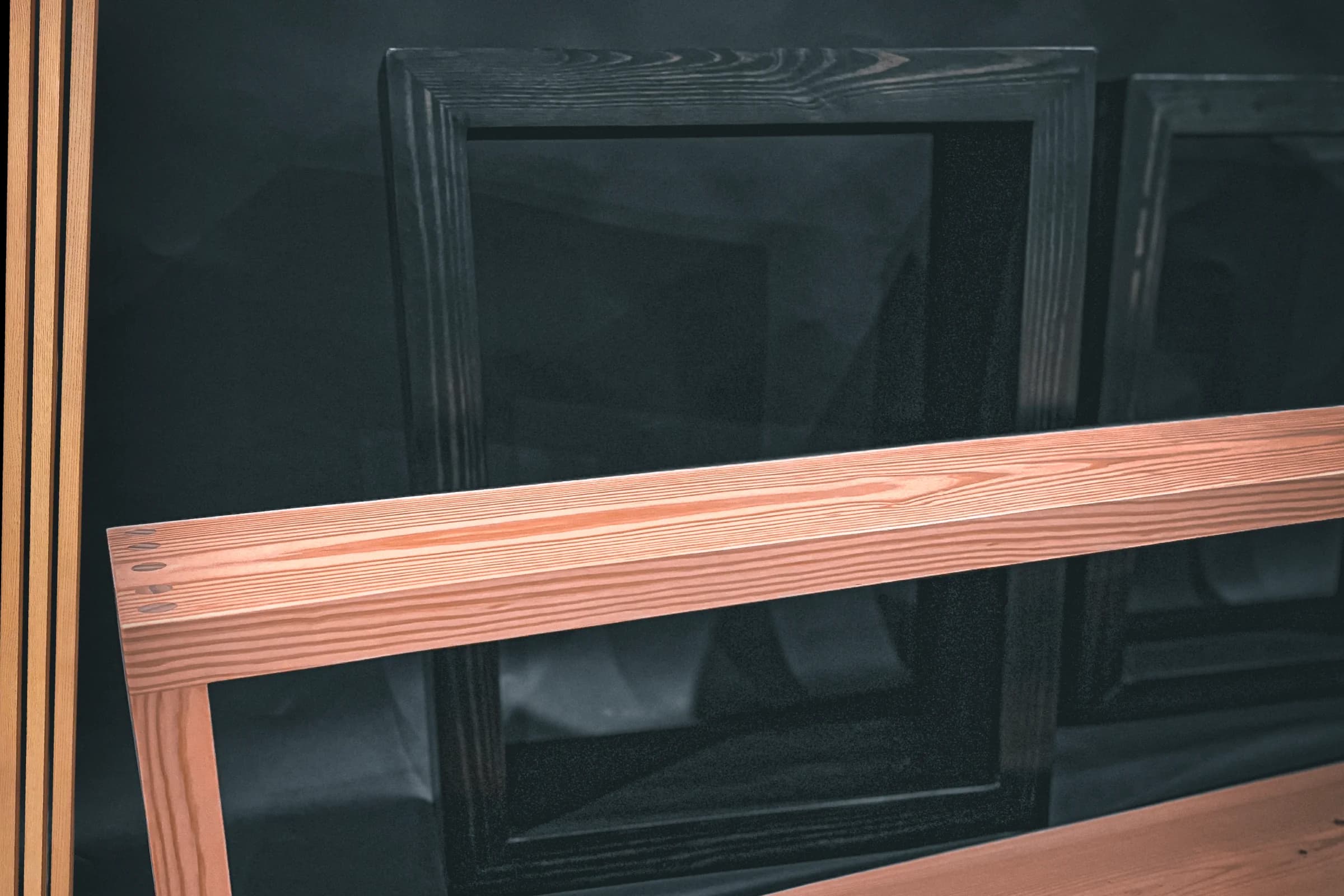 Custom wood mantel with visible grain against a dark paneled fireplace wall