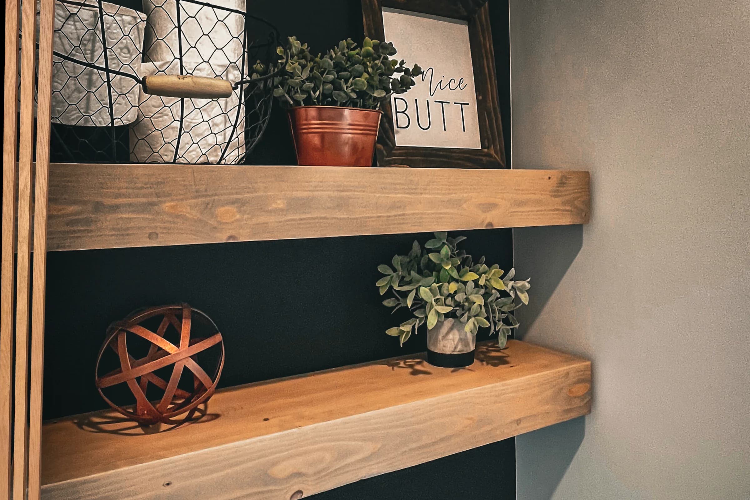Thick wood floating shelves displaying plants and decorative objects