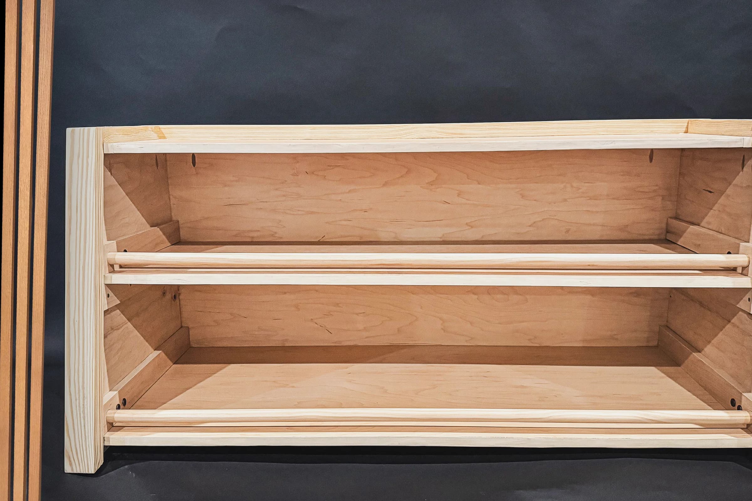 Low child-sized wood book display shelf with accessible open compartments