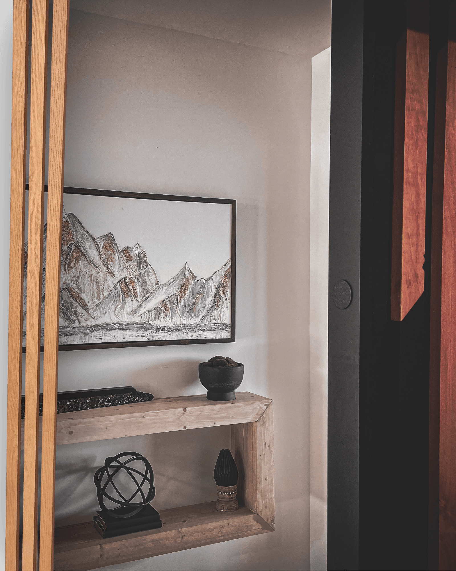 Custom wood console and artwork in a Still Am Studios interior