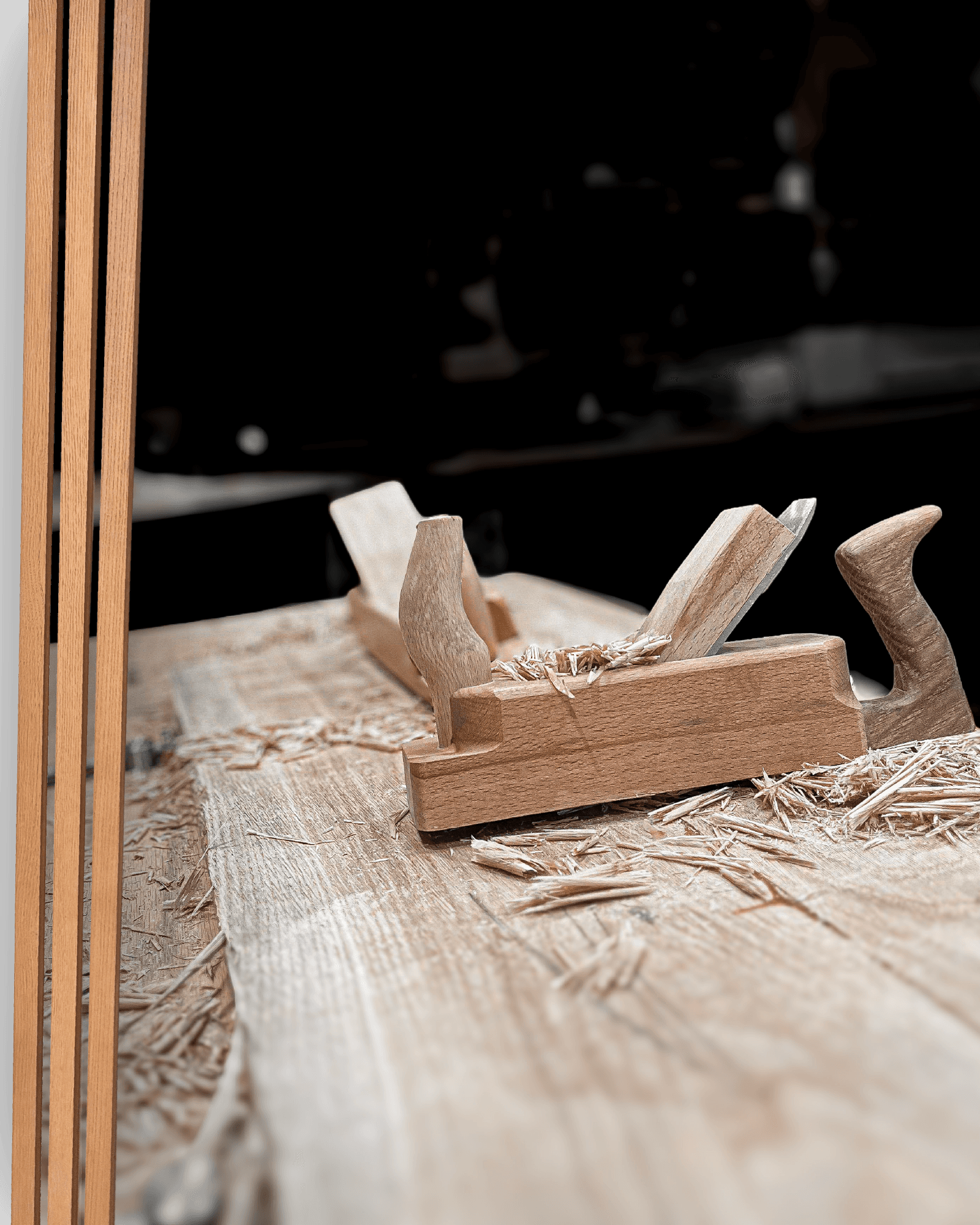 A wooden hand plane on a workbench