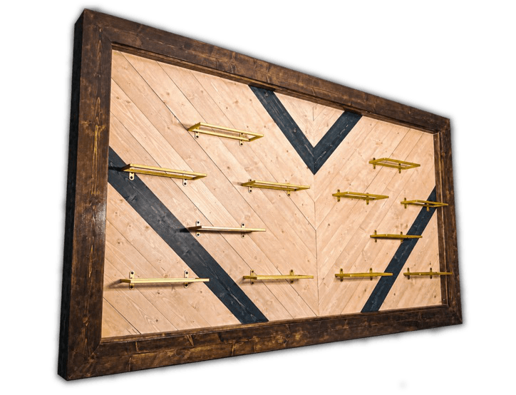 A finished wooden wall display with geometric inlays and brass shelves