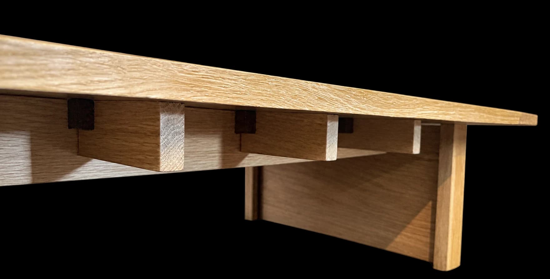 A close view of the joinery beneath a solid wood bench