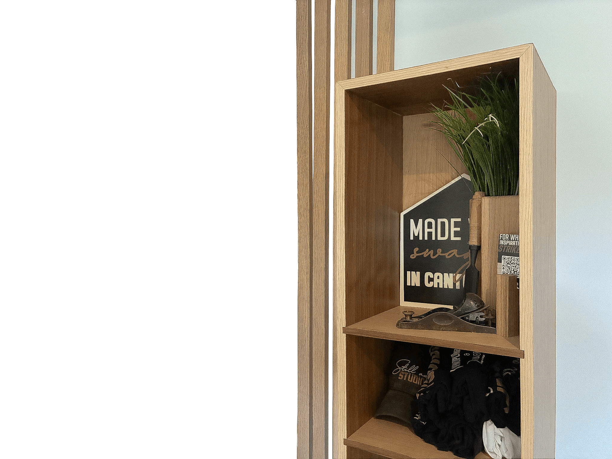 Still Am Studios display shelf with hand tools and studio signage