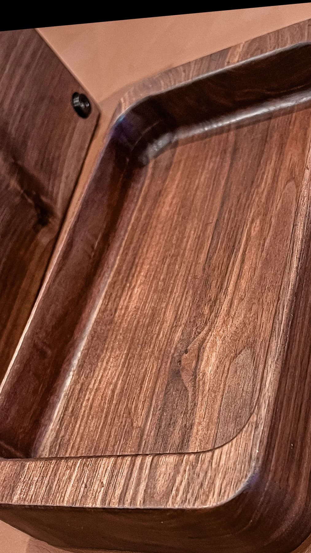 A handcrafted wooden tray with rich grain and rounded edges