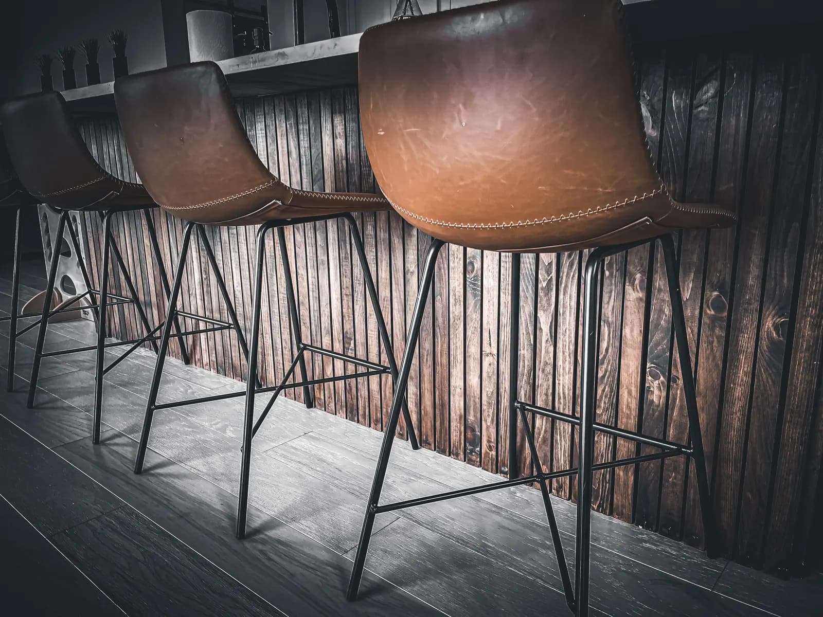 Row of custom commercial stools against a wood slat wall
