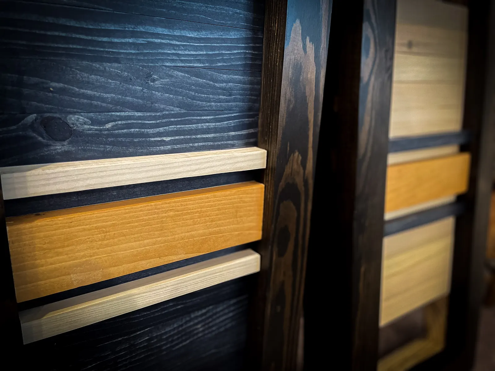 Dark custom cabinet with contrasting horizontal wood details