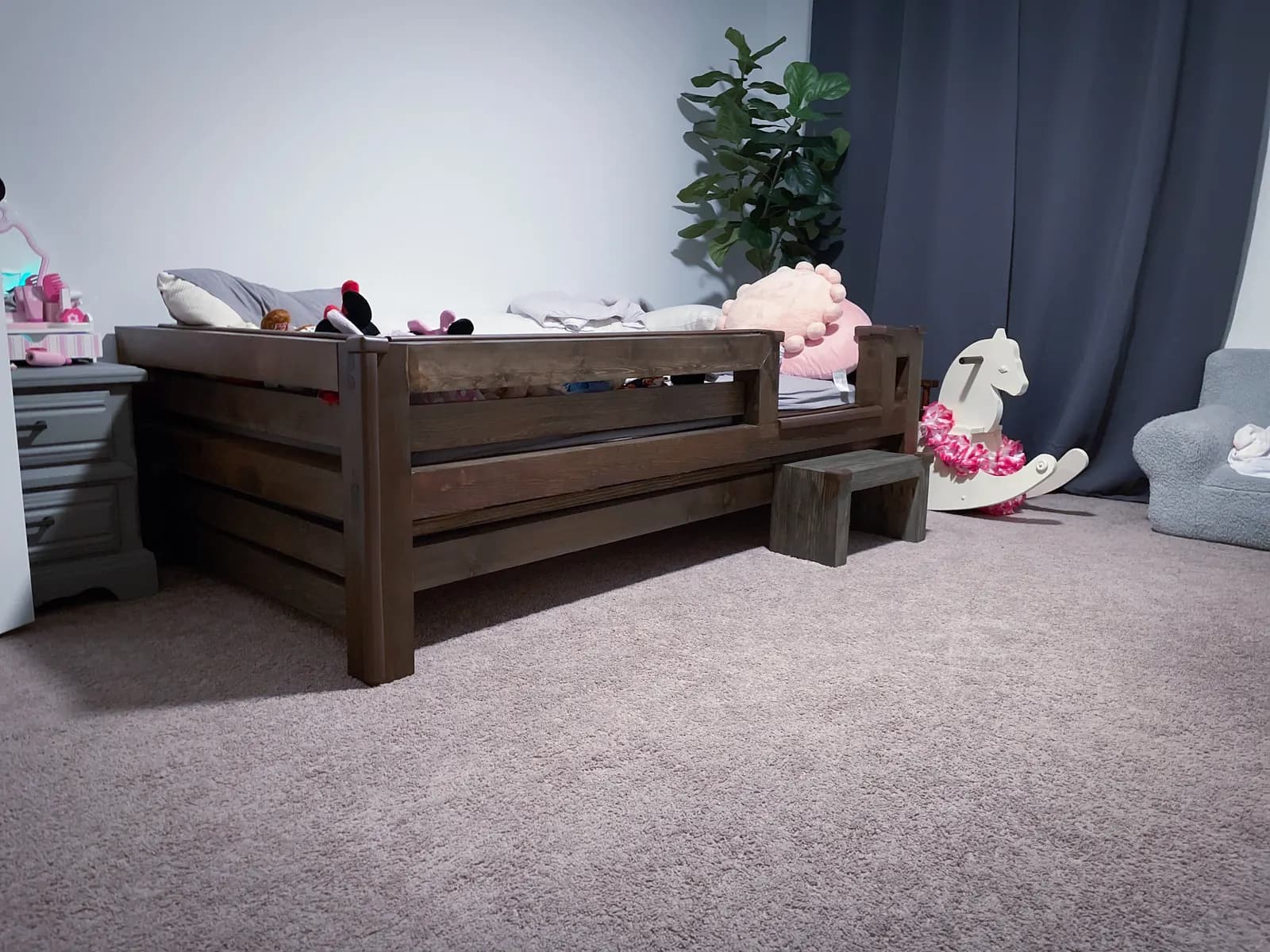 Dark custom child bed built from solid wood