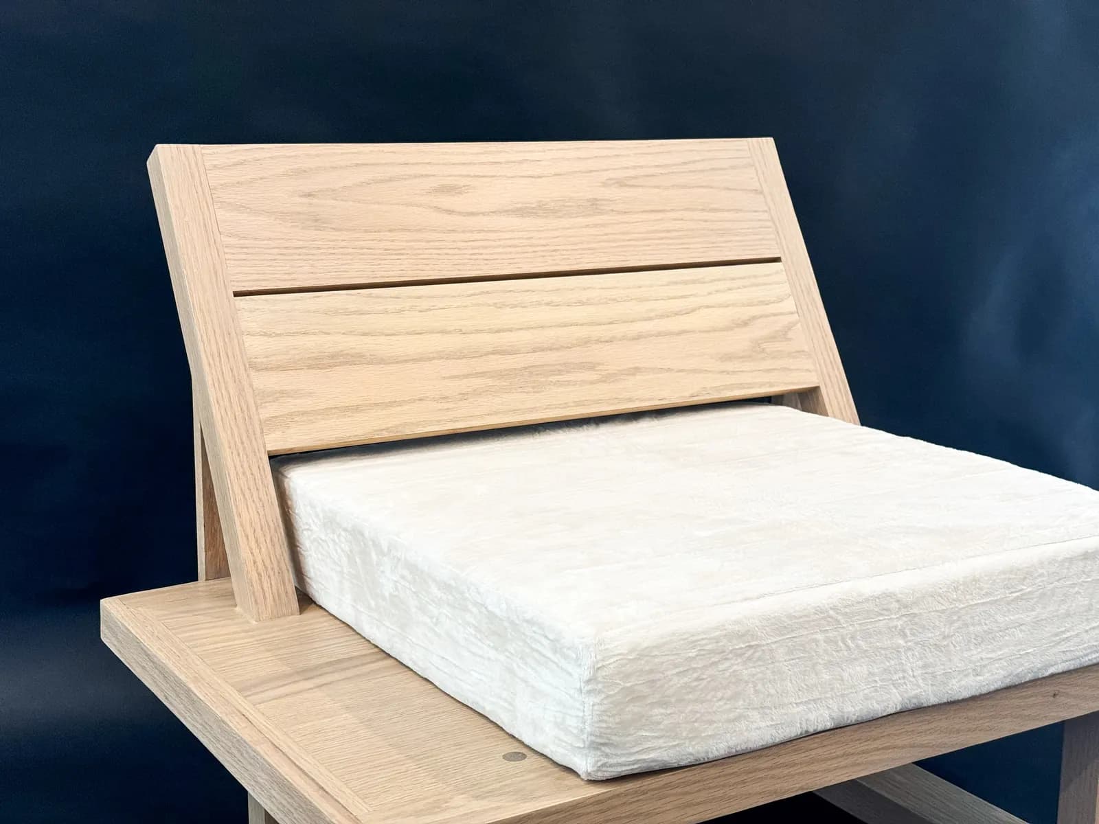 Custom solid wood lounge chair with fitted upholstery