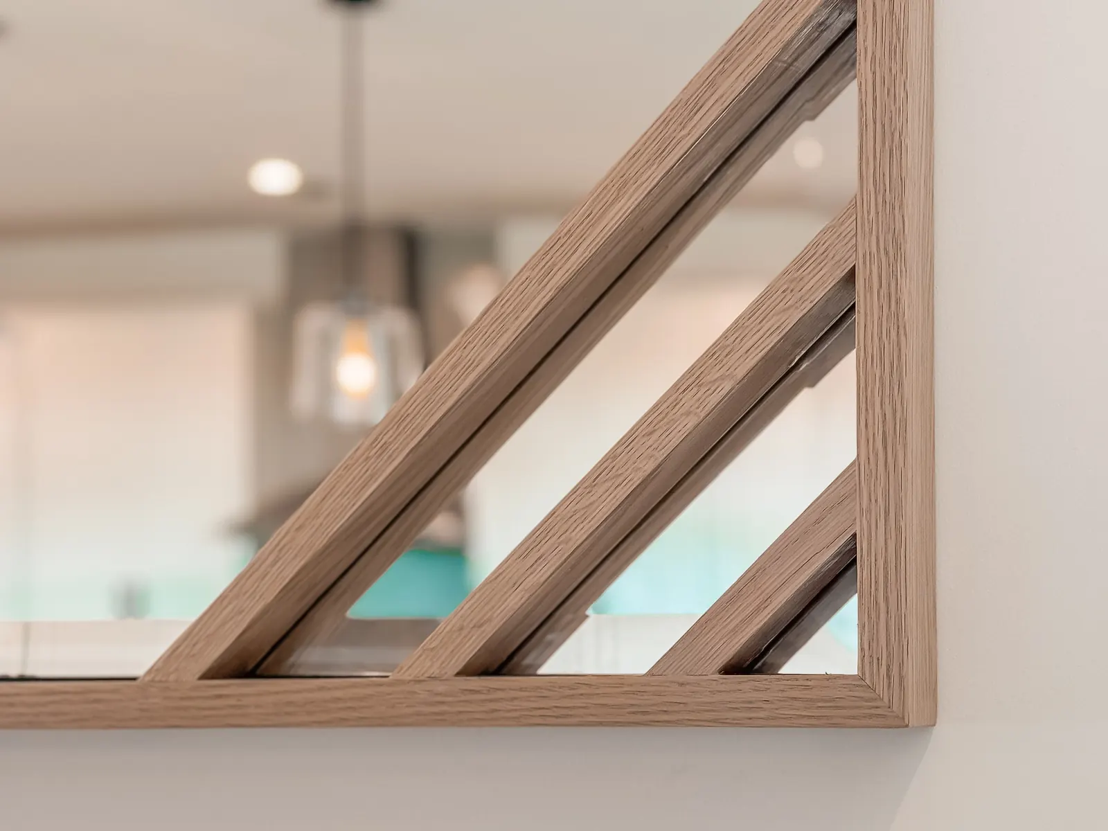 Geometric custom wood frame built around a round mirror