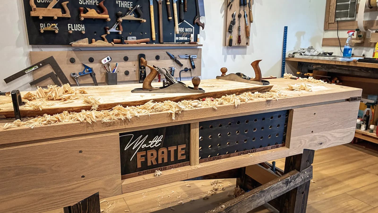 Still Am Studios workbench with hand planes and fresh wood shavings